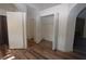 Hallway with open closet, archway, and wood-style flooring at 851 Brahma Ln, Henderson, NV 89002