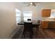 A naturally lit dining area featuring wood-look floors and stainless steel appliances at 851 Brahma Ln, Henderson, NV 89002