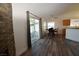 Bright dining area with wood-look floors, sliding glass door, and view of kitchen at 851 Brahma Ln, Henderson, NV 89002