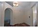 Spacious entryway featuring hardwood flooring, multiple storage closets, and arched doorway to other rooms at 851 Brahma Ln, Henderson, NV 89002