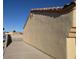 Close-up of the home's side, featuring textured stucco walls and a terracotta tile roof at 851 Brahma Ln, Henderson, NV 89002
