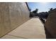 Wide concrete side yard of the house with stucco walls and some rear yard views at 851 Brahma Ln, Henderson, NV 89002