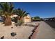 Exterior view of home showcasing the desert landscaping and well-maintained lawn at 851 Brahma Ln, Henderson, NV 89002