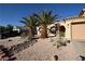 A charming home with desert landscaping and mature palm trees at 851 Brahma Ln, Henderson, NV 89002
