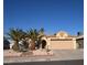 Charming single-story home featuring a two-car garage, desert landscaping, and two mature palm trees at 851 Brahma Ln, Henderson, NV 89002