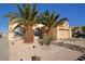 Charming single-story home with desert landscaping, mature palm trees, and a quaint front yard at 851 Brahma Ln, Henderson, NV 89002