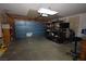 Spacious garage featuring overhead lighting, ample storage shelves, and easy access, perfect for vehicle storage and workshop space at 851 Brahma Ln, Henderson, NV 89002