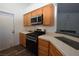 Cozy kitchen with stainless steel appliances, tile countertops and wood-look floors at 851 Brahma Ln, Henderson, NV 89002
