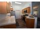 Well-lit kitchen featuring tile countertops, stainless steel appliances and breakfast bar at 851 Brahma Ln, Henderson, NV 89002