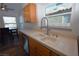 Traditional kitchen with stainless steel dishwasher and a view of the dining area at 851 Brahma Ln, Henderson, NV 89002