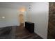 Living room showcasing hardwood floors, sleek black shelving, and an arched doorway leading to other rooms at 851 Brahma Ln, Henderson, NV 89002