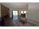 Open-concept living area with a stone fireplace, sliding glass doors, and adjacent dining space at 851 Brahma Ln, Henderson, NV 89002