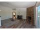 Bright living room features a stone fireplace, modern shelving, and hardwood floors at 851 Brahma Ln, Henderson, NV 89002