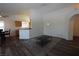 Open-concept living room with wood-look floors, contemporary rug and neutral paint at 851 Brahma Ln, Henderson, NV 89002