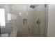 Modern tiled walk-in shower with bench and rainfall shower head at 851 Brahma Ln, Henderson, NV 89002