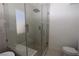 Walk-in shower featuring glass door, bench and rainfall shower head at 851 Brahma Ln, Henderson, NV 89002