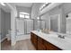 Bathroom features dual sinks, a tub, and shower with a glass door at 8658 Tom Noon Ave # 103, Las Vegas, NV 89178