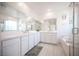 Bright bathroom featuring dual vanities, a soaking tub, and a separate glass-enclosed shower at 9256 Alden Pointe Ct, Las Vegas, NV 89143