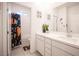 Well-lit bathroom featuring double sinks, leafy plants, and a space-themed shower curtain at 9256 Alden Pointe Ct, Las Vegas, NV 89143