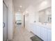 Bright bathroom featuring dual vanities and neutral-toned flooring, creating a clean and modern aesthetic at 9256 Alden Pointe Ct, Las Vegas, NV 89143