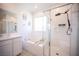 Bright bathroom featuring dual vanities, a soaking tub, and a separate glass-enclosed shower at 9256 Alden Pointe Ct, Las Vegas, NV 89143