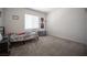 Comfortable bedroom with soft gray carpet, sunny window, and playful posters at 9256 Alden Pointe Ct, Las Vegas, NV 89143