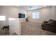 A versatile bonus room filled with natural light and plush carpeting, perfect for relaxation at 9256 Alden Pointe Ct, Las Vegas, NV 89143