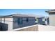View of neighborhood homes featuring neutral exteriors, dark trim, and solar panels against a mountain backdrop at 9256 Alden Pointe Ct, Las Vegas, NV 89143