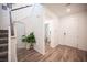 Bright foyer with wood-look flooring, a mirror, and a staircase leading to the upper level at 9256 Alden Pointe Ct, Las Vegas, NV 89143