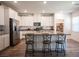 Well-lit kitchen featuring a large island, white cabinetry, and modern stainless steel appliances at 9256 Alden Pointe Ct, Las Vegas, NV 89143