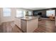 Open kitchen concept showcasing an island with bar seating overlooking the adjacent living space at 9256 Alden Pointe Ct, Las Vegas, NV 89143