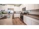 Close-up of the kitchen with stainless appliances, a center island, and sleek countertops at 9256 Alden Pointe Ct, Las Vegas, NV 89143