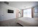 Bright main bedroom features neutral decor, plush carpeting, and balcony access at 9256 Alden Pointe Ct, Las Vegas, NV 89143