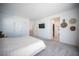 Bright main bedroom with plush carpeting, neutral decor, and access to ensuite bathroom at 9256 Alden Pointe Ct, Las Vegas, NV 89143