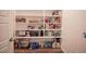 Walk-in pantry with white shelving, offering ample storage for food and household items at 9256 Alden Pointe Ct, Las Vegas, NV 89143