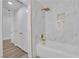 Modern bathroom featuring a tub with marble tile surround and gold fixtures at 9412 Mount Cherie Ave # 102, Las Vegas, NV 89129