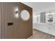 Bathroom featuring double sinks, wooden accent wall, modern lighting, and stylish mirrors at 9412 Mount Cherie Ave # 102, Las Vegas, NV 89129