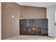 Close up of a modern fireplace with a black marble surround and wood accent wall at 9412 Mount Cherie Ave # 102, Las Vegas, NV 89129