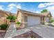Single story home with three-car garage and drought-tolerant landscaping at 9412 Mount Cherie Ave # 102, Las Vegas, NV 89129