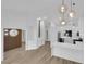 Open concept living and kitchen area featuring a large island, white cabinets, and modern lighting at 9412 Mount Cherie Ave # 102, Las Vegas, NV 89129