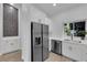 Kitchen showcasing stainless steel appliances, white cabinets, quartz countertops and a view of outdoors at 9412 Mount Cherie Ave # 102, Las Vegas, NV 89129