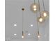 Statement lighting fixture with clear glass shades and brass accents above the Kitchen at 9412 Mount Cherie Ave # 102, Las Vegas, NV 89129