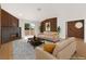 Modern living room featuring a fireplace, wood-slat wall, neutral furniture, and a sliding glass door at 9412 Mount Cherie Ave # 102, Las Vegas, NV 89129