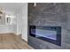 Living room featuring a modern electric fireplace and marble accent wall, leading into the bright bathroom at 9412 Mount Cherie Ave # 102, Las Vegas, NV 89129