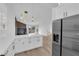 Open floor plan showcasing the kitchen and living area featuring modern lighting and a fireplace at 9412 Mount Cherie Ave # 102, Las Vegas, NV 89129