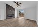 Bright living room featuring a ceiling fan, a modern fireplace, and a sliding door to the outside at 9412 Mount Cherie Ave # 102, Las Vegas, NV 89129