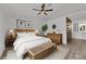 Staged main bedroom features ceiling fan and adjacent bathroom with double vanity at 9412 Mount Cherie Ave # 102, Las Vegas, NV 89129
