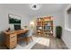 Staged home office with desk, chair, bookshelf and decorative lighting at 9412 Mount Cherie Ave # 102, Las Vegas, NV 89129