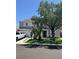 Charming two-story home featuring a spacious garage, well-maintained lawn, and mature trees for shade at 9511 Teton Vista Ave, Las Vegas, NV 89117