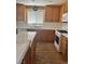 Functional kitchen featuring wooden cabinetry, white appliances, and a bright window overlooking the yard at 9511 Teton Vista Ave, Las Vegas, NV 89117